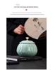Celadon Ceramic Tea Canister: Large Half-Pound Capacity Storage for Green or Black Tea - Porcelain Sealing Jar with Printed Design.