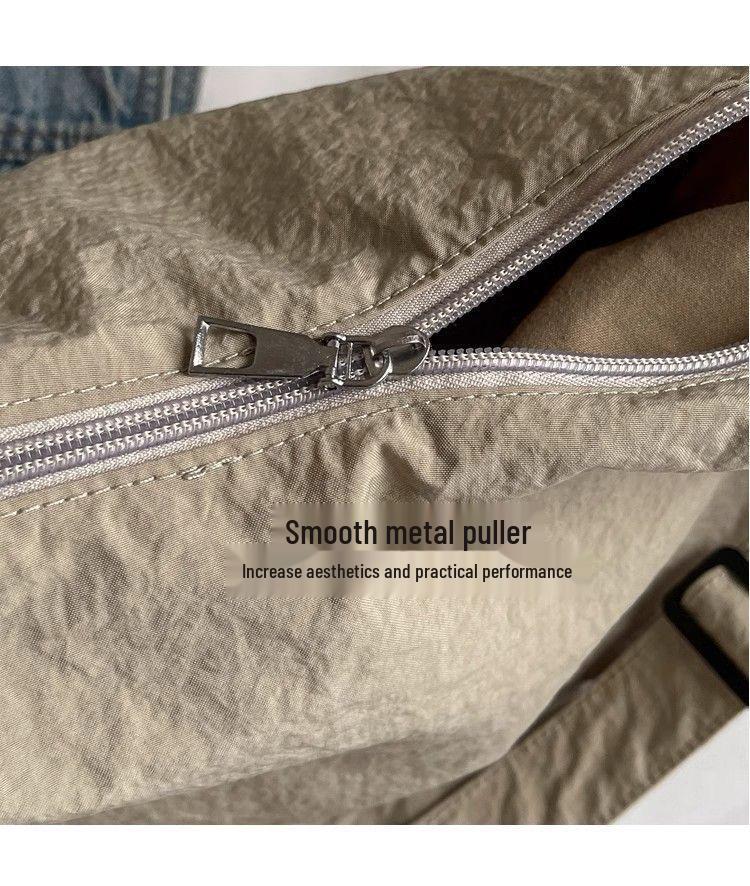 Japanese-Style Waterproof Nylon Dumpling Crossbody Bag: Sporty, Large-Capacity Tote for Men & Women, Ideal for Cycling & Relaxed Shoulder Wear.