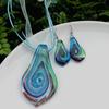 Trendy Blue Glass Ribbon Pendant Necklace & Earring Set - Perfect Seaside Vacation Accessory.