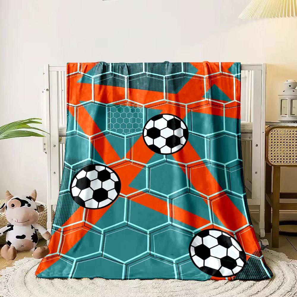 Hexagonal grid with soccer balls and bold orange diagonal accents. for all seasons blanket lunch break throw gift 80cm x 120cm