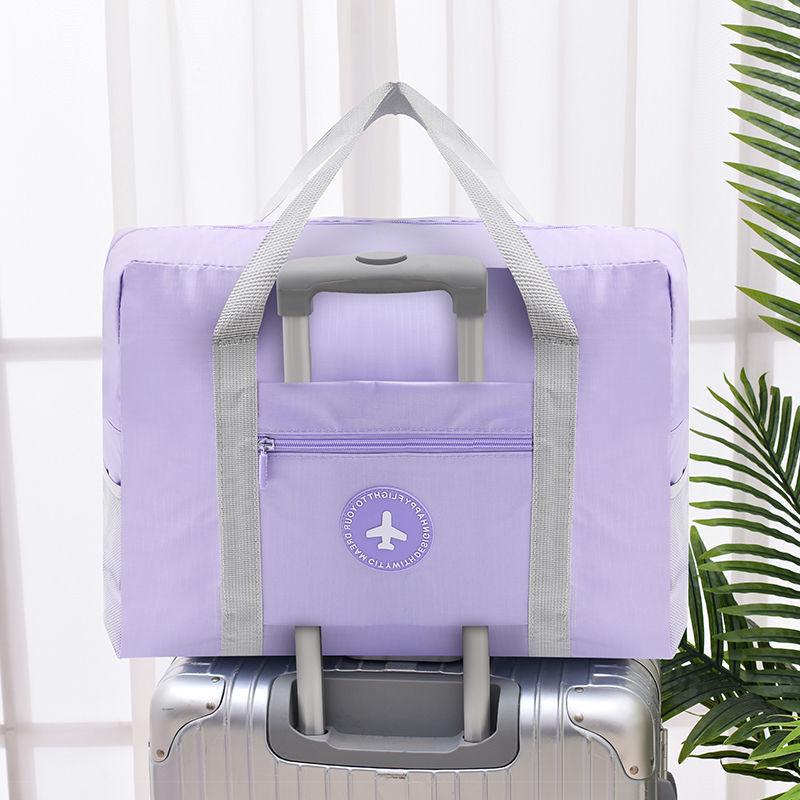 Compact travel bag: suitcase-compatible, hand-held, features an external pocket, handle slip-over design, with matching accessory bag.