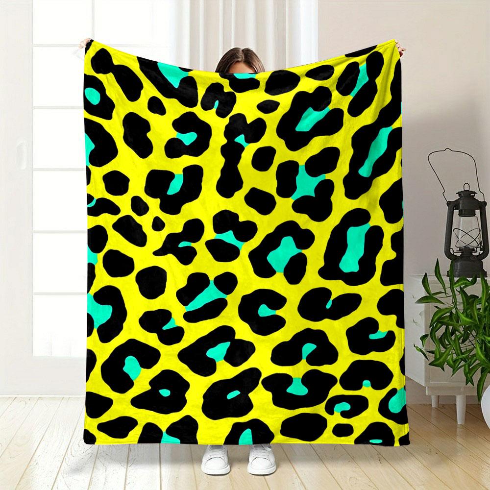 Black leopard spots with turquoise accents on a bright yellow background. for all seasons blanket lunch break throw gift