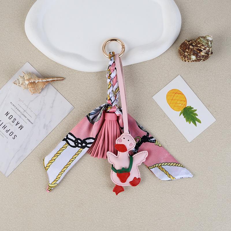 Cross-border small yellow duck leather fringed pendant creative keychain grass mold refueling duck bag pendant Christmas gift