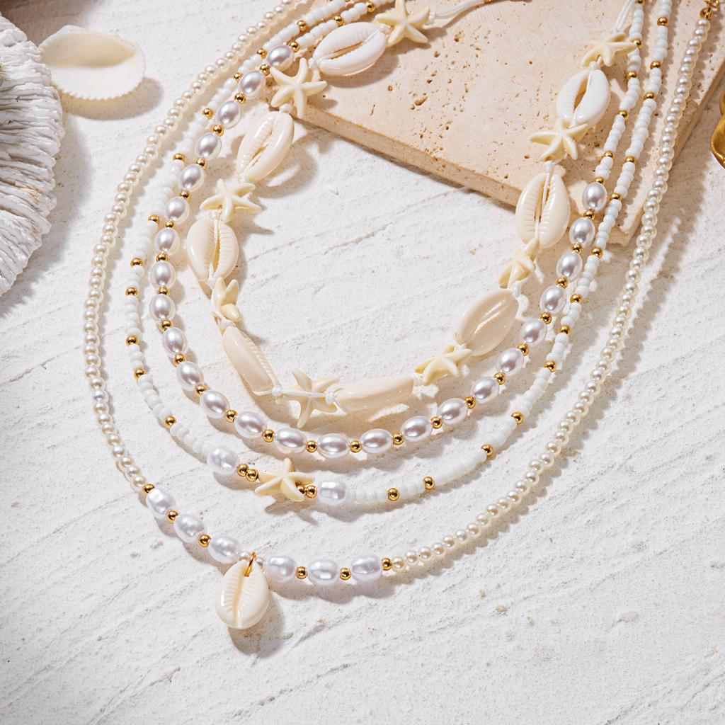 Bohemian Handgefertigter Seestern Sonne Anhänger Halskette für Damen Sommer Muschel Imitation Perle Reiskorn Perlen Choker Strandurlaub Schmuck