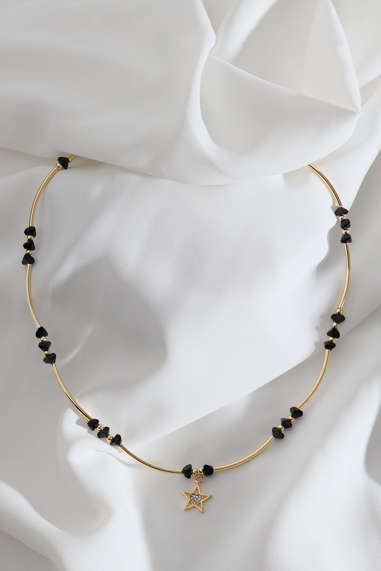 

Ожерелье золотого цвета с подвеской в ​​виде звезды из черной бусины и детали трубы