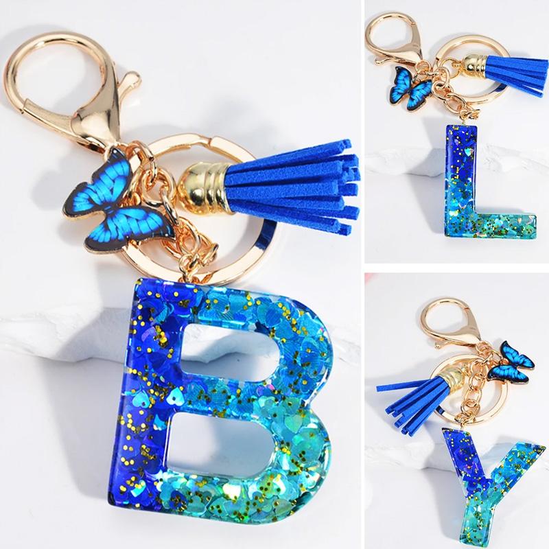 1 Stück Schriftzug Schlüsselanhänger für Rucksackanhänger Schlüsselanhänger Schlüsselring mit Quaste Schmetterling Niedlich Farbverlauf Harz Blau Pailletten