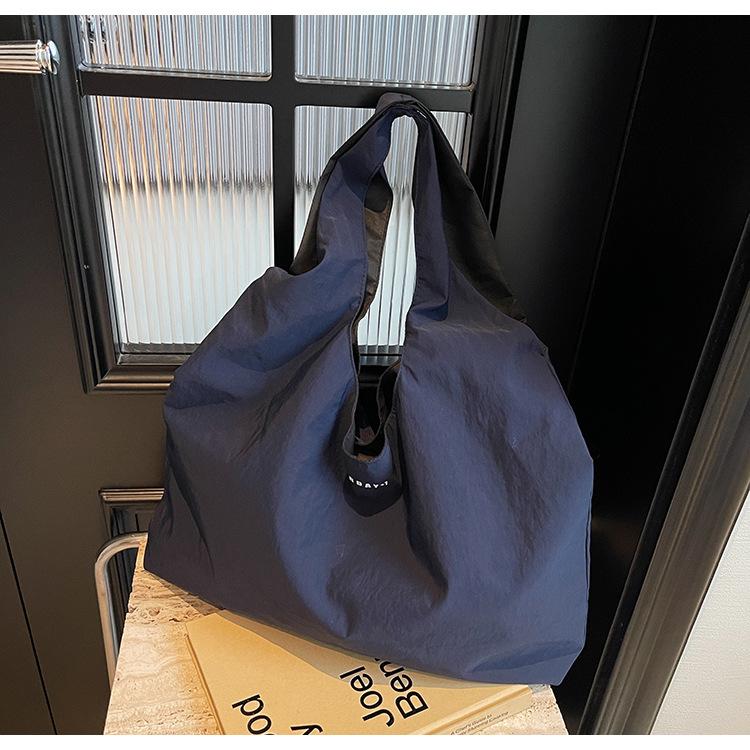 

Contrasting color letter casual handbag 2025 new simple Korean style shoulder bag lazy style simple canvas bag women 50*10*34 синий
