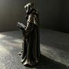 Tabletop Resin Sculpture with Hooded Character, Open Spell Book, and Bronze Style Finish for Shelf Display Use