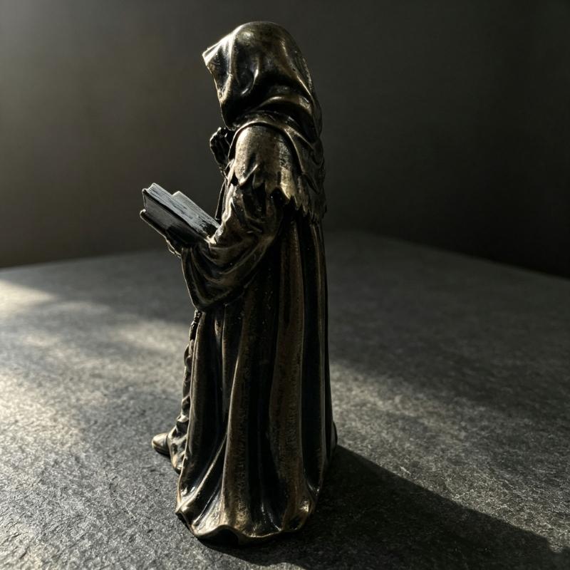Tabletop Resin Sculpture with Hooded Character, Open Spell Book, and Bronze Style Finish for Shelf Display Use