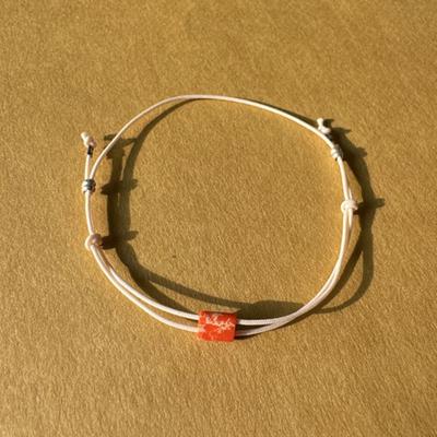 Emotionales [Baumwoll-] Armband Orange auf Creme
