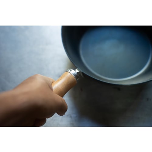 The Little China 24 Iron Frying Pan, a small iron wok that develops with use. Made in Japan, induction compatible, lightweight, no seasoning required,