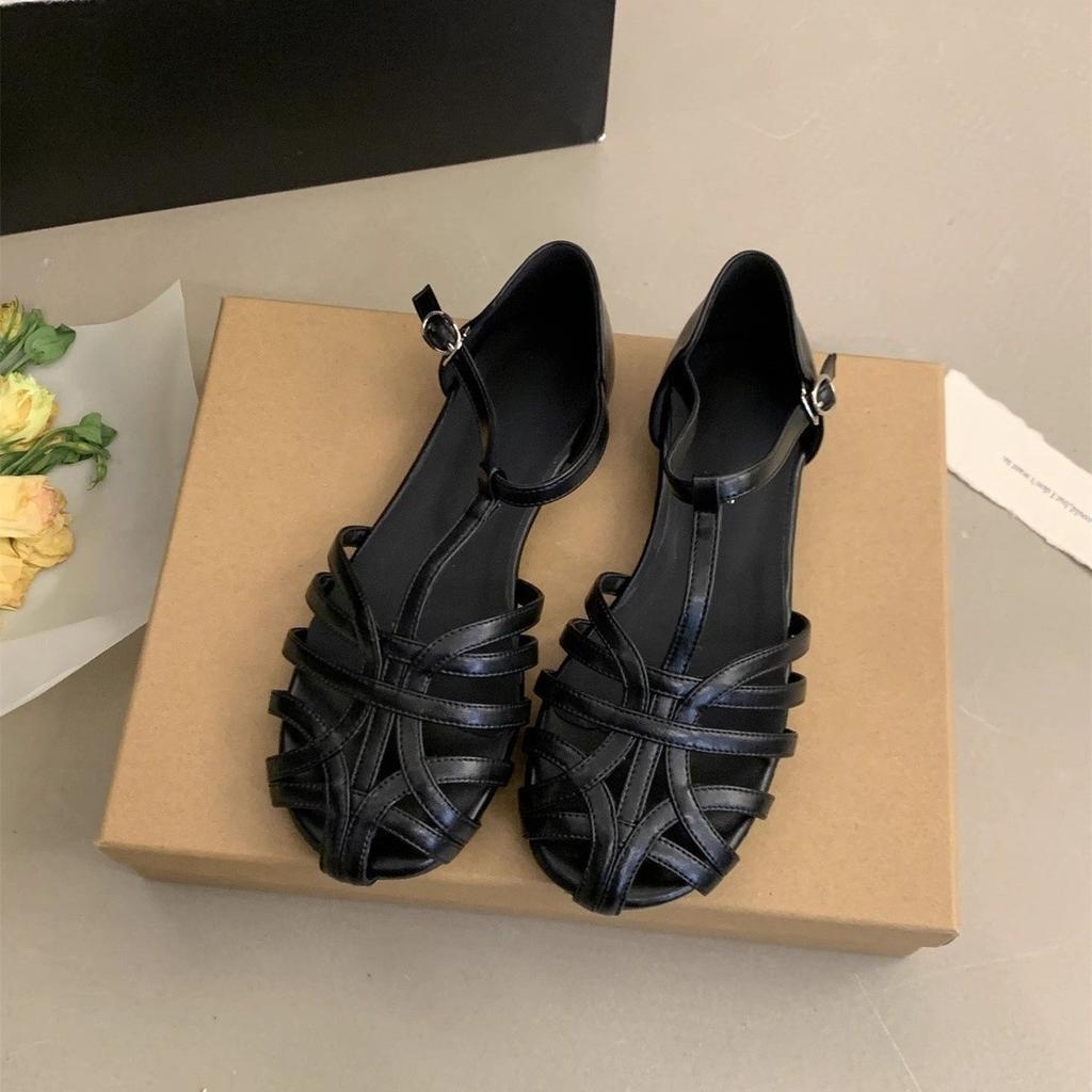 2025 neue Retro-Web-Baotou-Ein-Wort-Schnalle Flachsohlen-Sandalen Damen Sommerbekleidung hohle Schweinekäfigschuhe Römische Damenschuhe