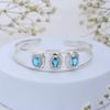 Blue Topaz Cuff Bracelet: Oval Gemstone, Sterling Silver