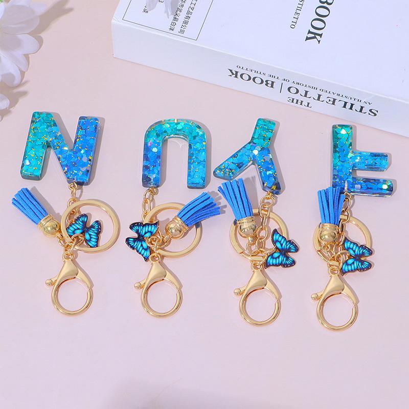 1 Stück Schriftzug Schlüsselanhänger für Rucksackanhänger Schlüsselanhänger Schlüsselring mit Quaste Schmetterling Niedlich Farbverlauf Harz Blau Pailletten