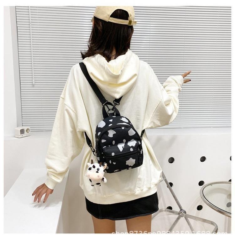 Schoolbag wholesale cow pattern canvas bag female messenger, new versatile ins wind shoulder bag Korean version Mori multi-purpose small backpack