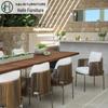 Outdoor Rattan Dining Set: Long Table with Casual Woven Chairs for Garden, Terrace, or Courtyard.
