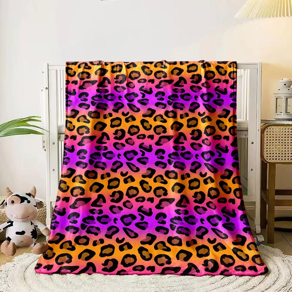 

Black leopard spots on a gradient background of orange, pink, and purple. for all seasons blanket lunch break throw gift 80cm x 120cm