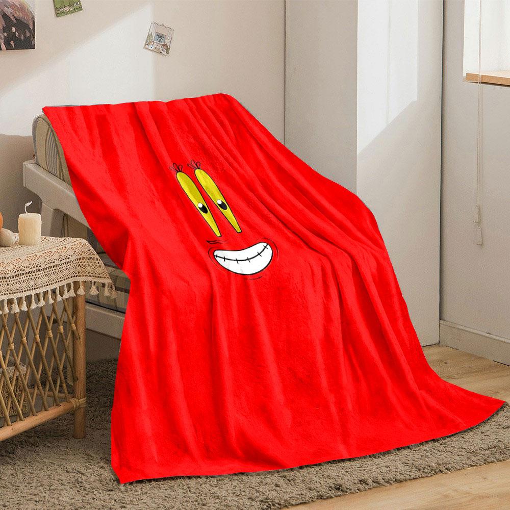 A cartoonish smiling face with big yellow eyes on a red background. for all seasons blanket lunch break throw gift
