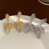 Light Luxury Zircon Leaf Earrings: Elegant Golden Leaf Studs with Silver Needle, Fashionable and Versatile Dangle Jewelry.