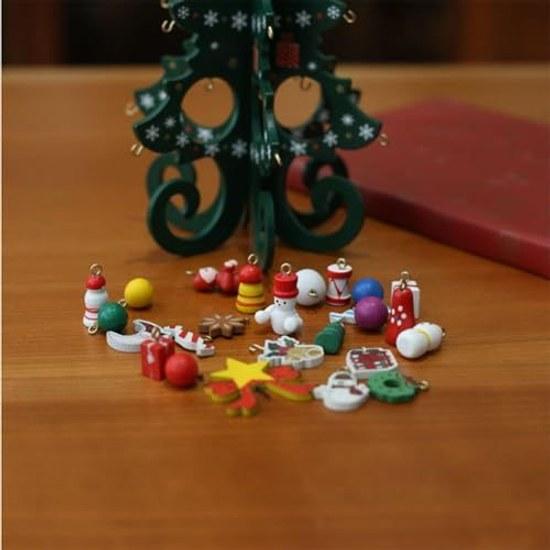 Christmas tree decoration colorful ornaments on green (green)