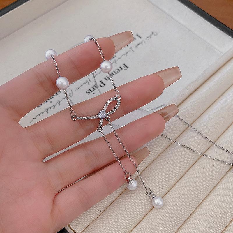 Bow pearl fringed necklace women's light luxury design titanium steel neck chain Internet celebrity collarbone chain