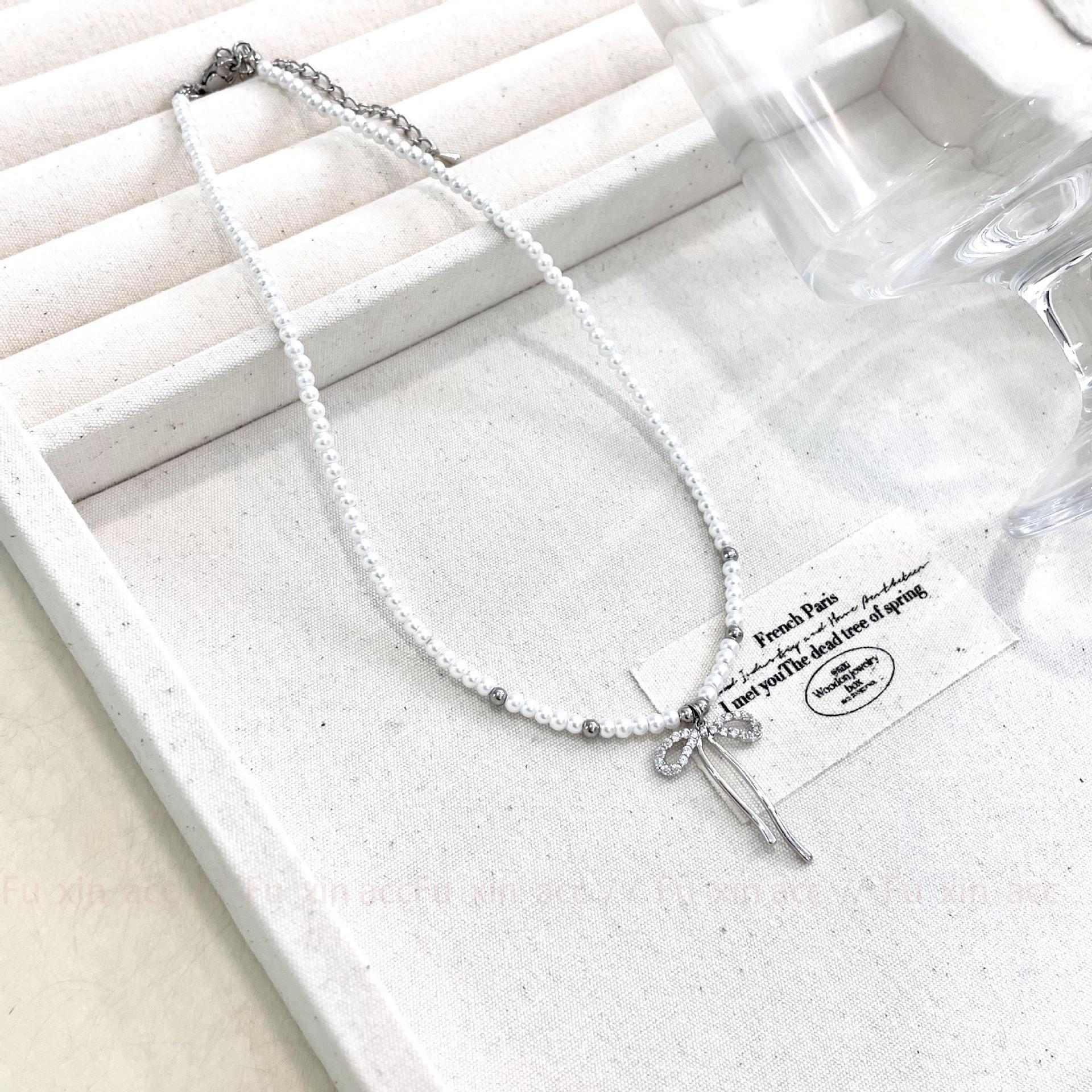 

Серебряное двухслойное ожерелье с подвеской в виде банта из жемчуга - высококачественная ключичная цепочка, легкий роскошный нишевый дизайн