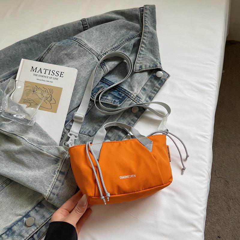 

2025 summer new pumping bag women s niche contrasting color splicing lazy wind crossbody fashion commuter backpack помаранчевий
