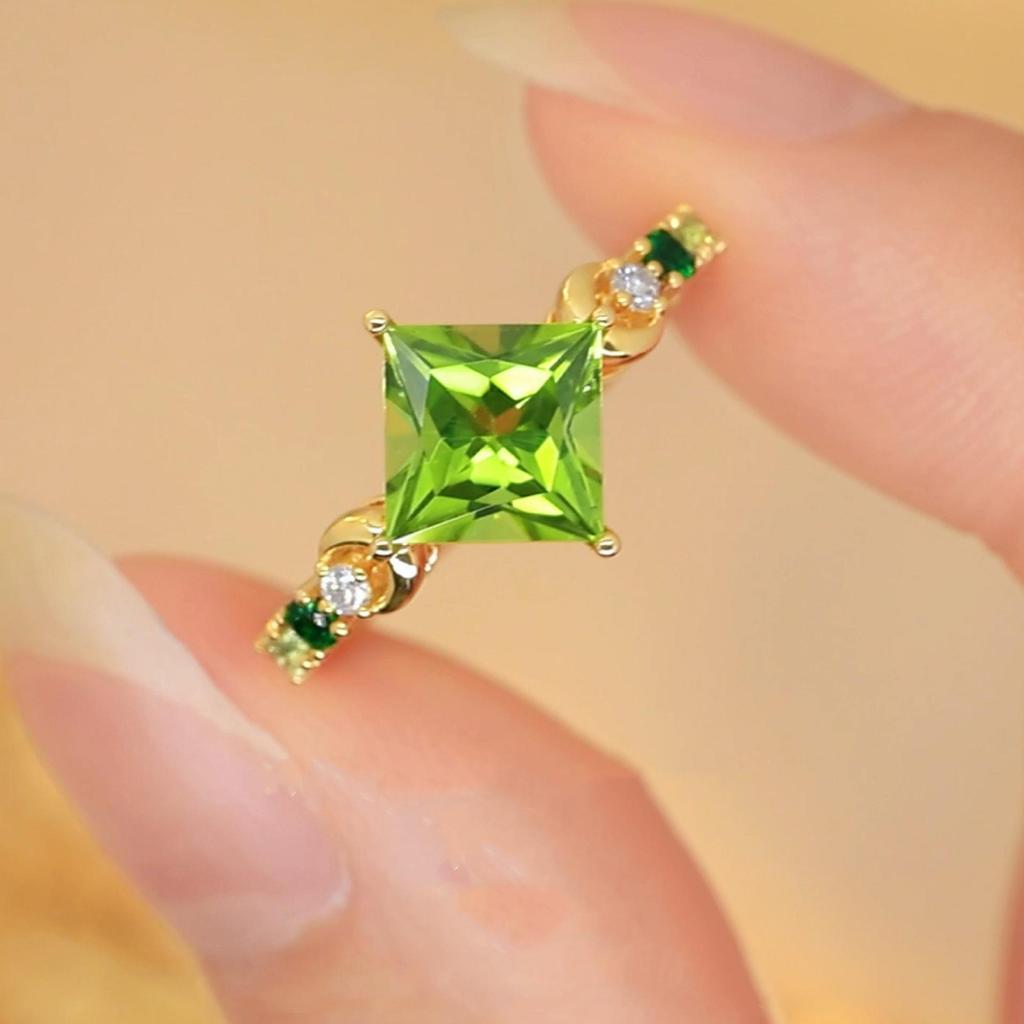 Yintai Fei Elegant Rhombus Facet Zircon Ring: 18k Gold-Plated Copper with Diamond and Green Peridot.