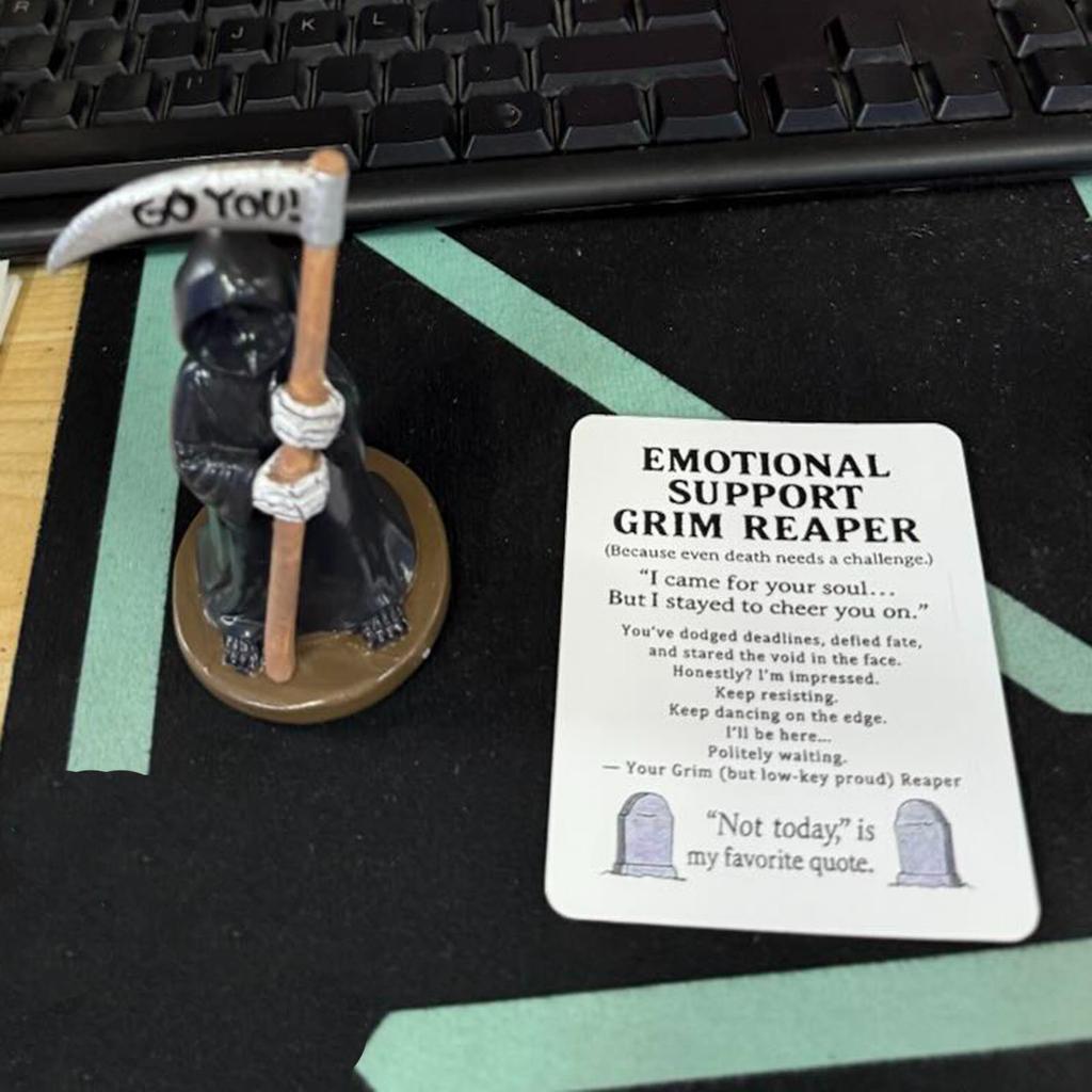 An Emotional Companion Ornament Based On The Sickle And Death , With A Cold And Stern Shape That Hides Power, Standing Quietly At The Table To Provid