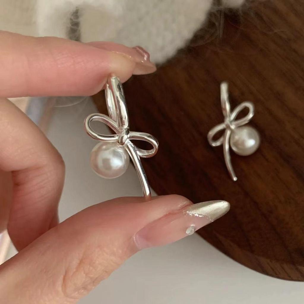 Silver Bow and Pearl Earrings: Elegant, Luxurious, Versatile Women's Accessories
