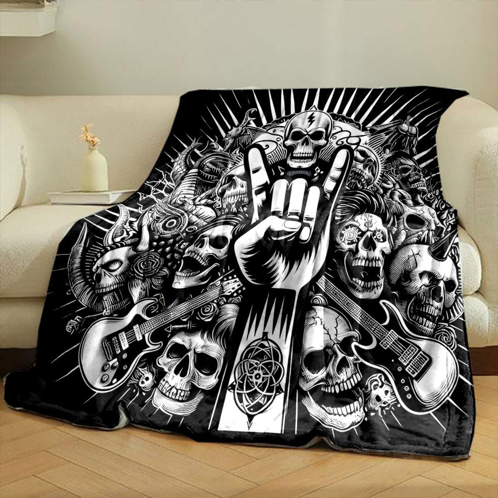 A skull-heavy design with a "rock on" hand gesture, guitars, and dark motifs. for all seasons blanket lunch break throw gift