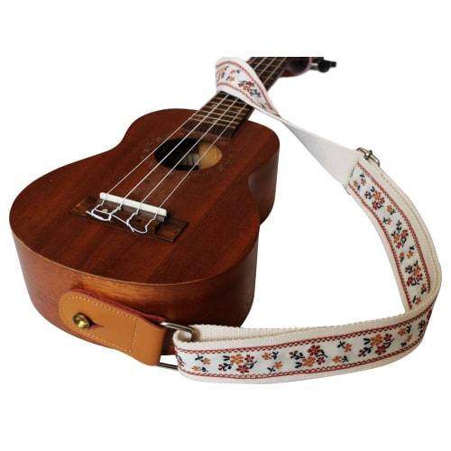 This is a genuine leather ukulele strap with a vintage floral embroidery, an original design by MUSIC FIRST. It is a ukulele shoulder strap with a gen