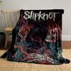 A skeletal figure intertwined with red veins, holding a human heart. for all seasons blanket lunch break throw gift