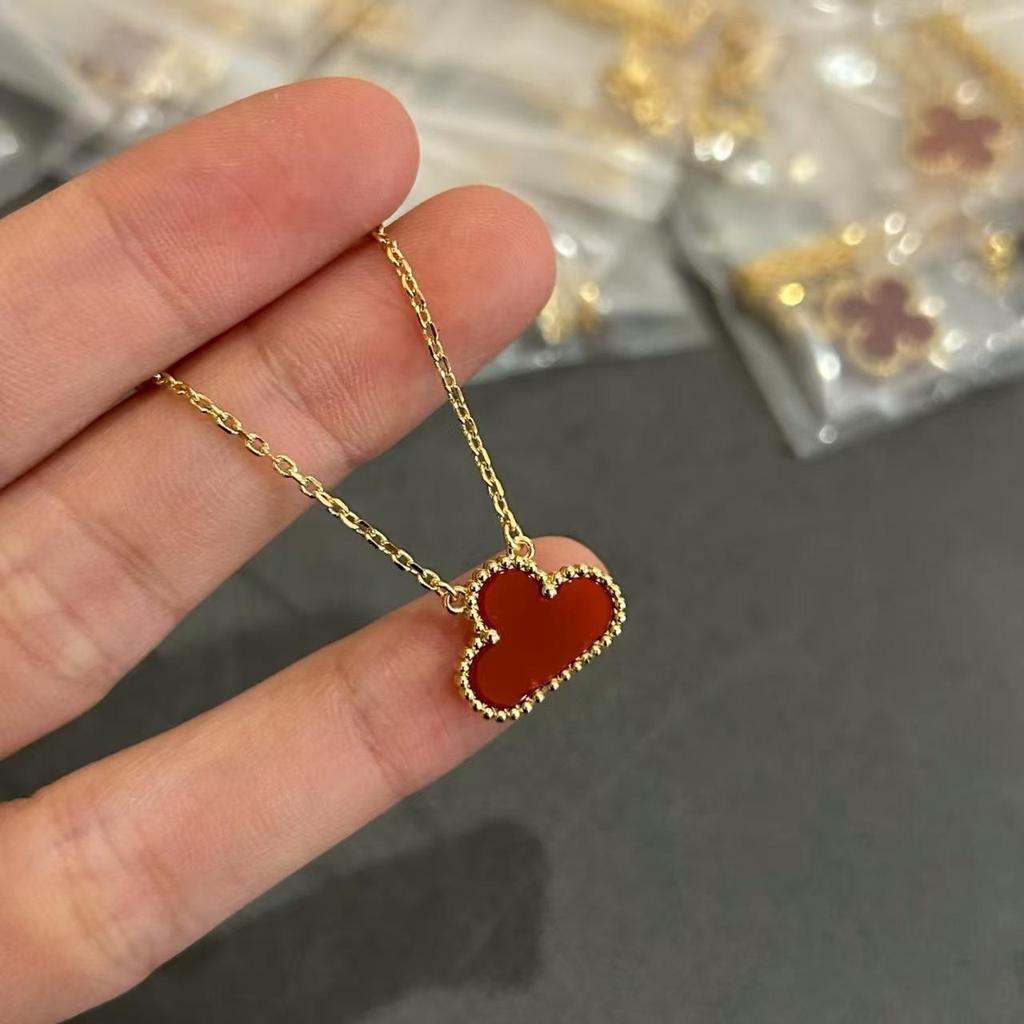 Náhrdelník Van Cleef se čtyřlístkem: Zlatý přívěsek pro ženy s pětilistým designem, bílou perletí, červeným achátem a diamantem.