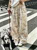 Women's plus-size wide-leg pants with stylish graffiti prints, suitable for wearing at home and for walks.