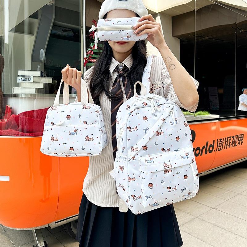 New cartoon printed women's schoolbag, junior high school and primary school students reduce the burden of three-piece backpack, large-capacity
