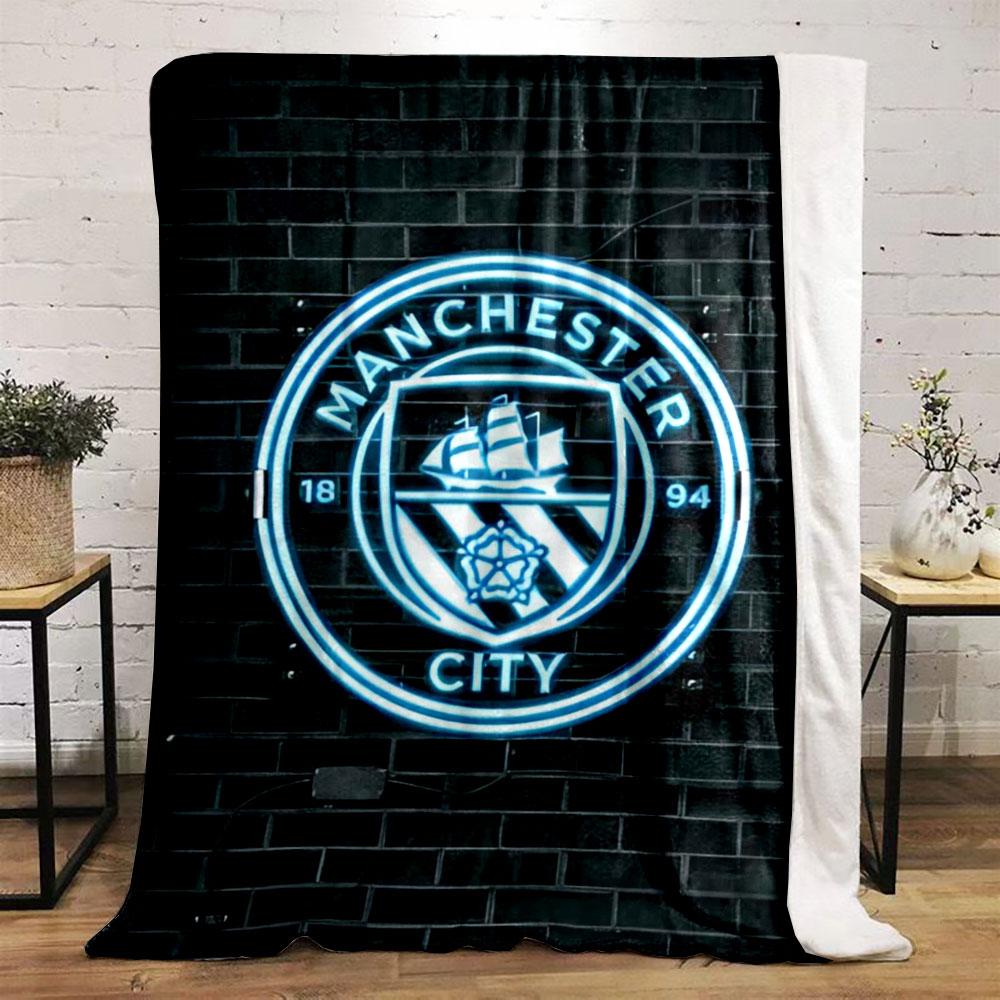 A glowing neon emblem with a ship, rose, and "Manchester City" text. for all seasons blanket lunch break throw gift