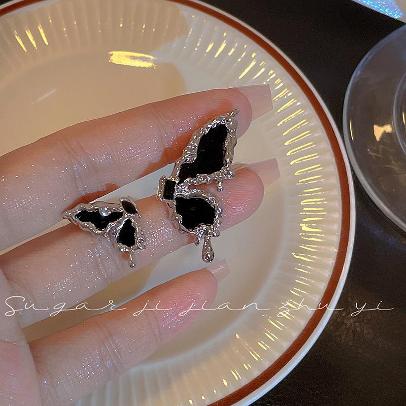 

Sweet and cool babes asymmetrical dark butterfly earrings women s niche design sense personalized stud earrings senior