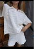 2026 New Spring and Summer European and American Beach Blouse Short Sleeve Solid Color Empty Knitted Cardigan Shorts Two-piece Women's Set