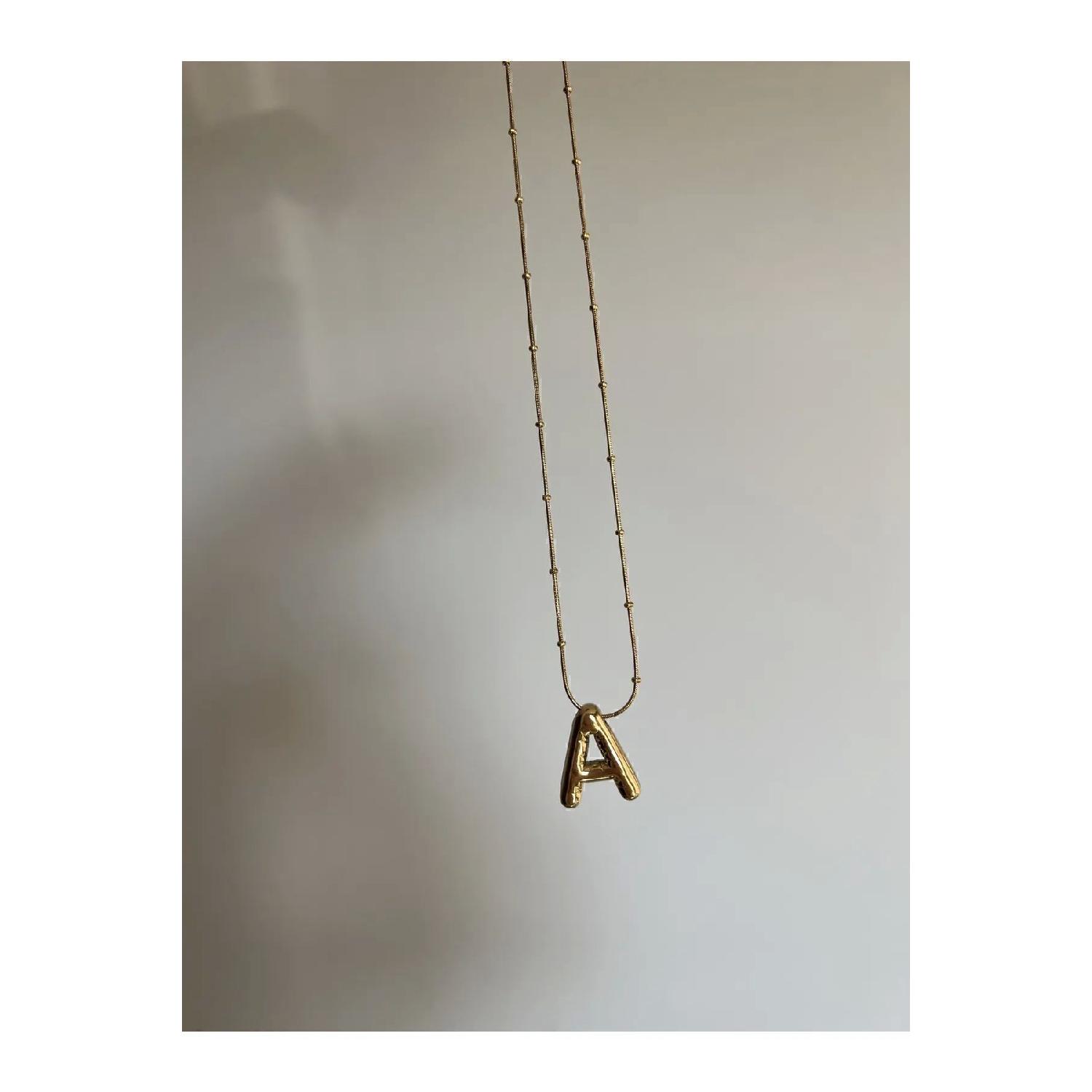 

Curved Letter A Necklace золотой