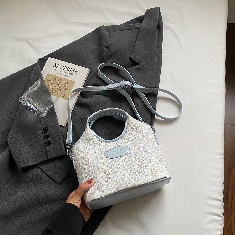 

Popular sweet wind hand carrying bucket bag women s new versatile niche design shoulder messenger bag