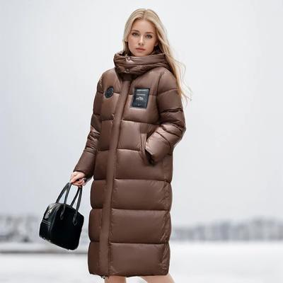 Doudoune Longue pour Femme Nouvelle pour l'Hiver Tendance Tempérament Haut de Gamme Couleur Unie à Capuche Ample Rembourrée Chaude Veste Manteau