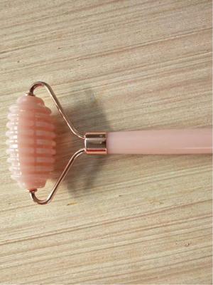 Heart-Shaped Rose Quartz Facial Roller & Gua Sha Massager for Skin Lifting and Muscle Relaxation.
