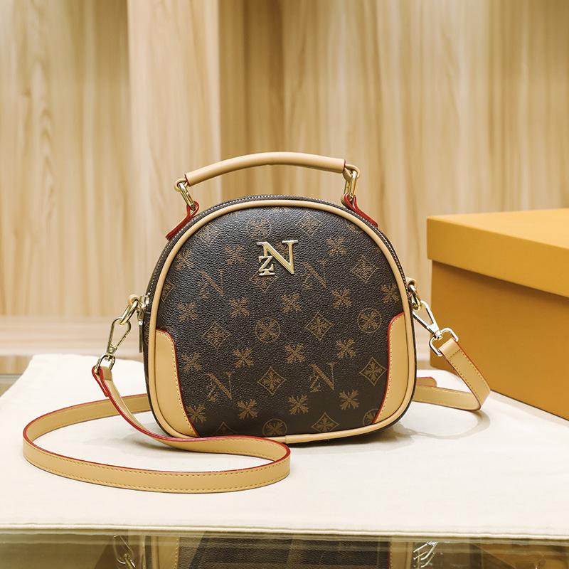 

Spring and summer new women s bags retro printing hand carry small round bags large capacity round cake bags fashionable shoulder messenger bags темно-коричневого