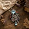 Mushroom Cottage Pendant Necklace with Dimensional Relief, Floral and Leaf Details, Blue Teardrop Dangle, and Vintage-Inspired Alloy Finish