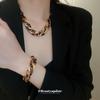 Meillard Leopard Print Jewelry Set: Interlocking Earrings, Necklace, Bracelet, and Ear Studs.