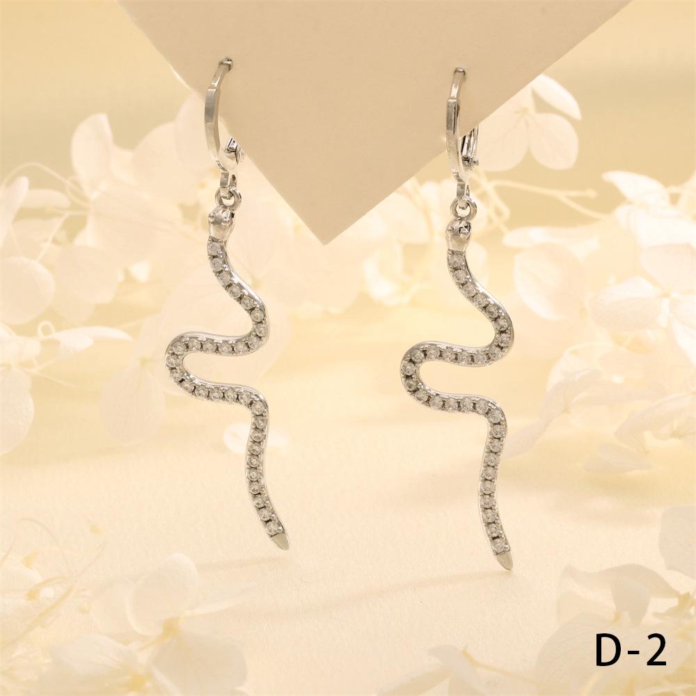 

Exotic Emerald & Zircon Snake Ear Cuffs: Bold, Fashionable Statement Earrings