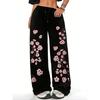 Women's black and pink jogging pants with a cherry blossom print inspired by Japanese floral designs