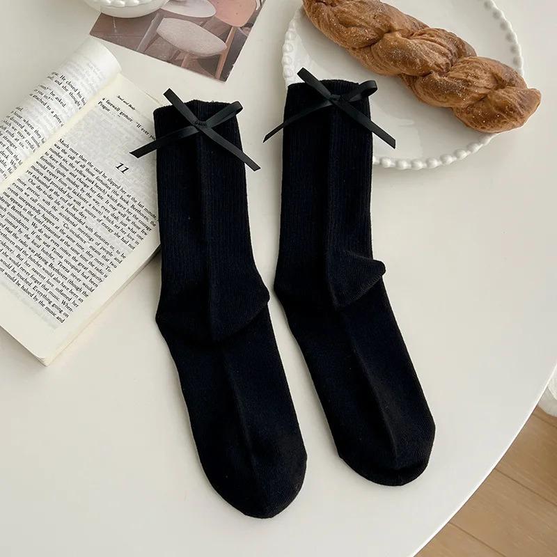 Chaussettes mi-mollet à nœud papillon doux JK japonais pour femmes, chaussettes à nœud au talon, chaussettes décontractées noires et blanches en bouclette, chaussettes de sport en coton pour filles