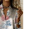 The lady's long-sleeved button-down shirt features a printed and delicate floral design, making it perfect for both romantic and casual styles.